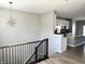 Open-concept view of a modern kitchen from the stairs, highlighting the stainless appliances and counterspace at 6882 Equality Blvd, Carmel, IN 46033