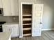 The kitchen features a pantry with functional pull-out shelving for organized food storage at 6882 Equality Blvd, Carmel, IN 46033