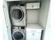 A well-organized laundry room, complete with modern washer and dryer, built-in storage, and cabinets at 6882 Equality Blvd, Carmel, IN 46033