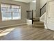 Inviting living area featuring durable floors, with views of the staircase and a sunny window at 6882 Equality Blvd, Carmel, IN 46033
