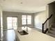 The living room boasts an island and a sliding glass door leading to the outside at 6882 Equality Blvd, Carmel, IN 46033
