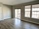 A cozy living room with large windows and a sliding glass door to the balcony at 6882 Equality Blvd, Carmel, IN 46033