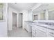 Bright bathroom featuring double vanity with granite countertop and view into the walk-in closet at 7156 Firestone Rd, Whitestown, IN 46052