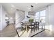 Elegant dining area featuring a modern chandelier, stylish seating, and large windows for natural light at 7156 Firestone Rd, Whitestown, IN 46052