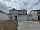 Charming two-story home featuring a three car garage and stylish stone accents, complemented by a cozy front porch at 7156 Firestone Rd, Whitestown, IN 46052