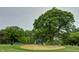 Scenic golf course view featuring a sand trap and mature trees on a beautifully manicured lawn at 7156 Firestone Rd, Whitestown, IN 46052
