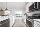 Close-up view of a well-appointed kitchen with stainless steel appliances and sliding glass doors to the backyard at 7156 Firestone Rd, Whitestown, IN 46052