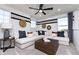 Modern living room with a white sectional sofa, black and white accent pillows, and decorative wall hangings at 7156 Firestone Rd, Whitestown, IN 46052
