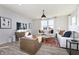 Cozy living room featuring modern decor, a comfortable seating arrangement, and a large window with natural light at 7156 Firestone Rd, Whitestown, IN 46052