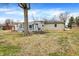 The exterior features stone and siding, a large backyard, and a screened-in porch at 725 Queenswood Dr, Indianapolis, IN 46217