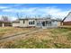 The exterior features stone and siding, a large backyard, and a screened-in porch at 725 Queenswood Dr, Indianapolis, IN 46217
