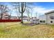 Large backyard with a storage shed, leafless trees, and grass at 725 Queenswood Dr, Indianapolis, IN 46217