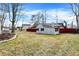 Large backyard with a storage shed surrounded by leafless trees at 725 Queenswood Dr, Indianapolis, IN 46217