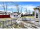 Backyard features a weathered wood deck, lush lawn and storage shed at 725 Queenswood Dr, Indianapolis, IN 46217