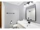 This renovated bathroom offers a sleek vanity, modern fixtures, and a stylish, neutral color scheme at 725 Queenswood Dr, Indianapolis, IN 46217