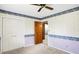 Bedroom boasts neutral carpet, double door closet, and decorated wall with chair rail at 725 Queenswood Dr, Indianapolis, IN 46217