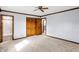 Bright bedroom features a ceiling fan, neutral carpet, and a closet at 725 Queenswood Dr, Indianapolis, IN 46217