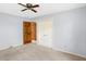 Neutral bedroom features ceiling fan, light blue walls, and closet at 725 Queenswood Dr, Indianapolis, IN 46217