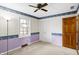 Comfortable carpeted bedroom features double door closet, window, and chair rail design at 725 Queenswood Dr, Indianapolis, IN 46217