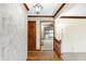 Entryway featuring hardwood floors, decorative trim and a view into the light-filled living area at 725 Queenswood Dr, Indianapolis, IN 46217