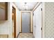 Hallway has neutral floral wallpaper, tile floor and lighting fixture at 725 Queenswood Dr, Indianapolis, IN 46217