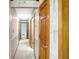 Hallway with paneled wood doors and neutral carpeting at 725 Queenswood Dr, Indianapolis, IN 46217