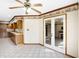 Open kitchen and dining area with tiled floor and access to outdoor patio at 725 Queenswood Dr, Indianapolis, IN 46217