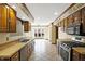 Bright kitchen with classic tile floor, wood cabinets, and stainless steel appliances at 725 Queenswood Dr, Indianapolis, IN 46217