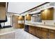 Traditional kitchen with wood cabinets, light countertops and tile floor at 725 Queenswood Dr, Indianapolis, IN 46217