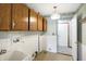 Laundry room with cabinetry, utility sink and access to another room at 725 Queenswood Dr, Indianapolis, IN 46217