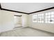 Bright living room with hardwood trim and large windows providing ample natural light at 725 Queenswood Dr, Indianapolis, IN 46217