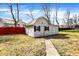 A backyard storage shed with a gambrel roof, gray siding, and dark shutters at 725 Queenswood Dr, Indianapolis, IN 46217