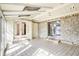 Bright sunroom with tiled floor, stone wall, and skylights at 725 Queenswood Dr, Indianapolis, IN 46217