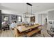 The open dining area is adjacent to the living room and a modern kitchen, with a decorative light fixture at 7384 Standish Ln, Avon, IN 46123