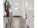 Bright entryway with wood-look flooring, a console table, stylish mirror and natural light at 7384 Standish Ln, Avon, IN 46123