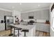 Contemporary kitchen with stainless appliances, granite counters, an island with seating and gray cabinets at 7384 Standish Ln, Avon, IN 46123