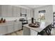 Bright kitchen featuring granite countertops, stainless steel appliances, gray cabinets, and island seating at 7384 Standish Ln, Avon, IN 46123