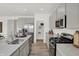 A modern kitchen with gray cabinets, stainless steel appliances, granite countertops, and an island sink at 7384 Standish Ln, Avon, IN 46123