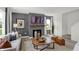 A modern living room with a fireplace, a flatscreen TV, stylish furniture, and neutral tones at 7384 Standish Ln, Avon, IN 46123