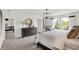 Bright main bedroom showcasing a large bed and dresser, with a sitting nook by the window at 7384 Standish Ln, Avon, IN 46123