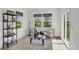 Sitting room with natural light, shiplap walls, stylish decor, and a view of the backyard at 7384 Standish Ln, Avon, IN 46123