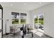 Sitting room with shiplap walls, stylish decor, natural light, and a sliding door with backyard access at 7384 Standish Ln, Avon, IN 46123