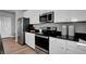 This kitchen features stainless steel appliances including a microwave, oven, and refrigerator at 7385 Standish Ln, Avon, IN 46123