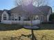 A beautiful backyard features grass, a tree and a wooden fence for privacy at 7437 Vineyard Dr, Fishers, IN 46038