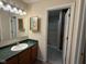 Bathroom featuring green marble countertops and a large mirror at 7437 Vineyard Dr, Fishers, IN 46038