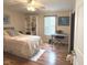 Bedroom featuring wood floors, white trim, shelving, ceiling fan and a window to provide great natural light at 7437 Vineyard Dr, Fishers, IN 46038