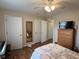 Well-lit bedroom with wood floors and a ceiling fan at 7437 Vineyard Dr, Fishers, IN 46038