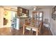 Eat-in dining area featuring hardwood floors, ceiling fan, and glass display cabinets, adjacent to kitchen at 7437 Vineyard Dr, Fishers, IN 46038