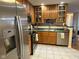 Well-lit kitchen featuring stainless steel appliances and wood cabinetry at 7437 Vineyard Dr, Fishers, IN 46038