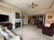 Open-concept living room with fireplace seamlessly connects to the kitchen and dining area at 7437 Vineyard Dr, Fishers, IN 46038
